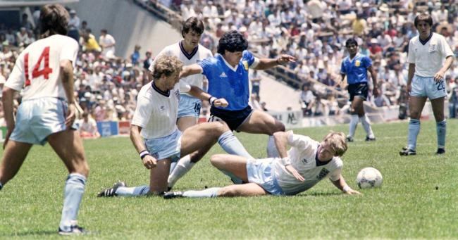 Diego Maradona dribbles past three English defenders during the 1986 World Cup quarterfinal match